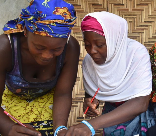 Women in BOLT program looking at chart on wall