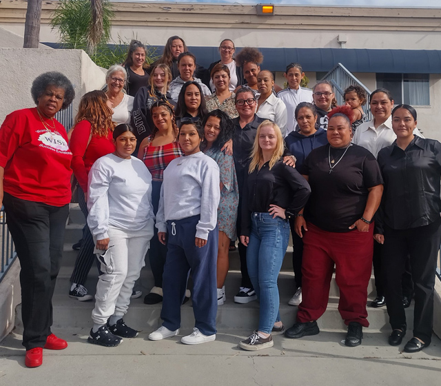 Women in BOLT program looking at chart on wall