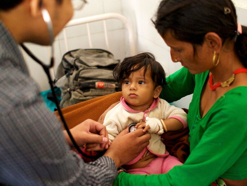Mother, baby and nurse at a pediatric checkup in rural Nepal.
