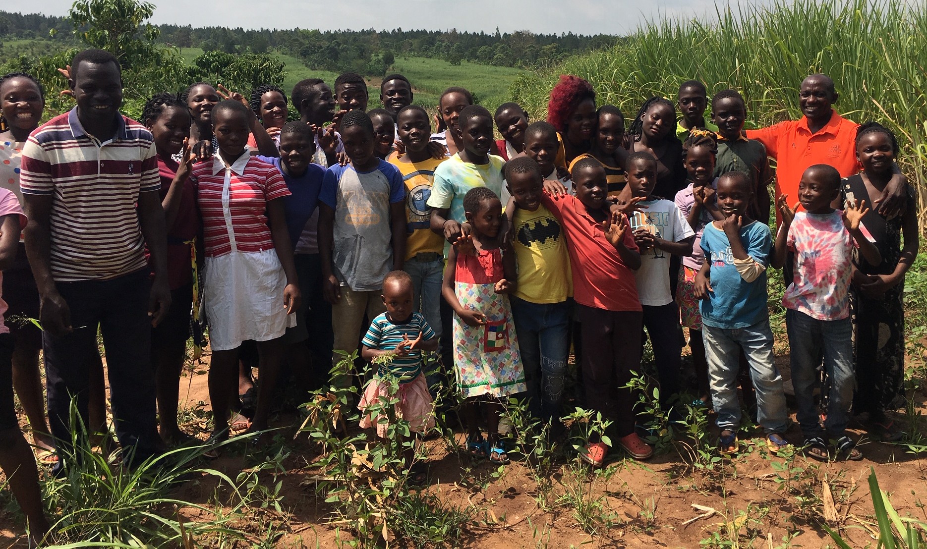 Paul and many children on the farm at the Orphans' Centre.