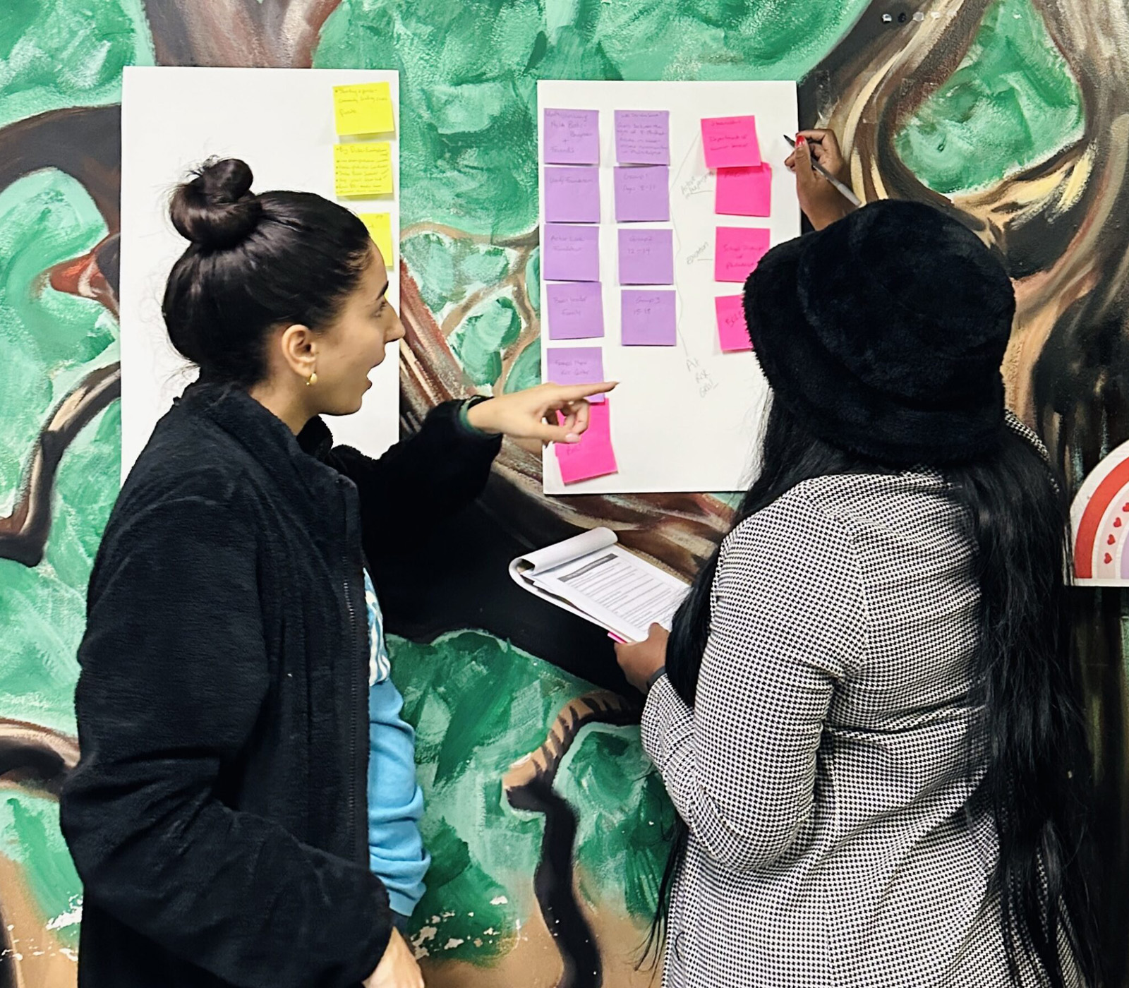 GY23_BOLT_640x560 Women in BOLT program looking at chart on wall