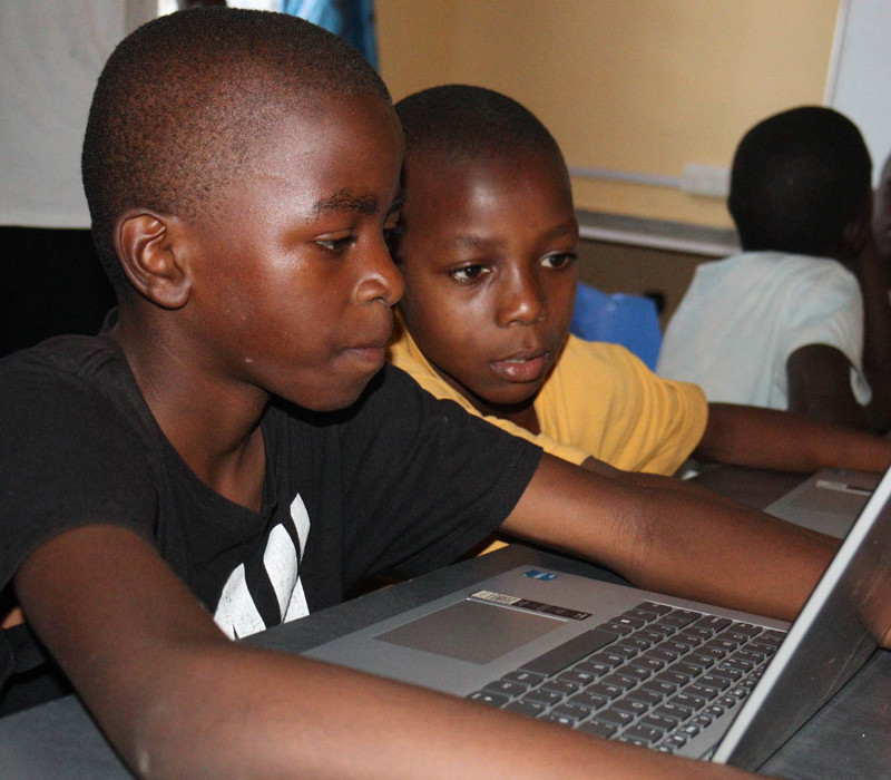 GY22_E2E_Finale Report_640x560 Two boys working in the Kiwimbi computer lab