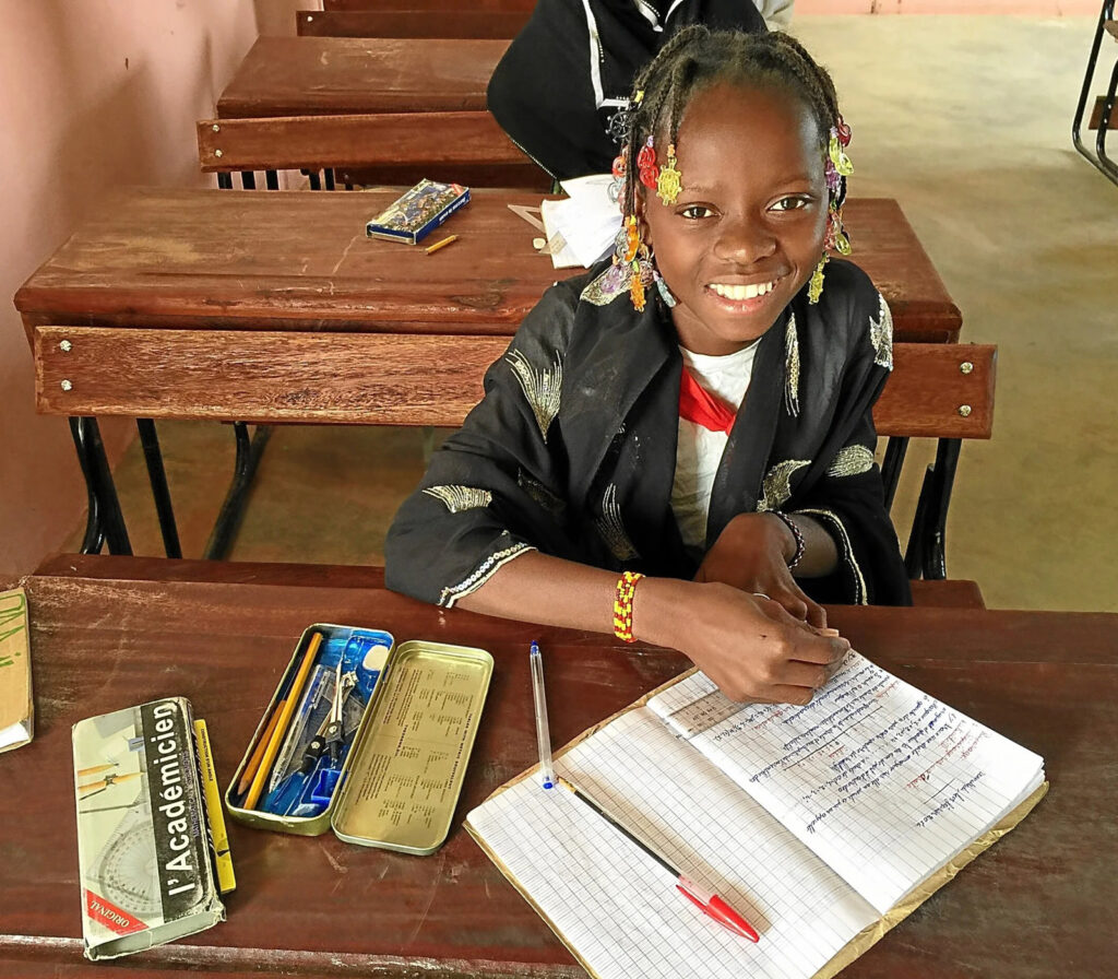 Current Grantees 14 Student at wooden desk with workbook